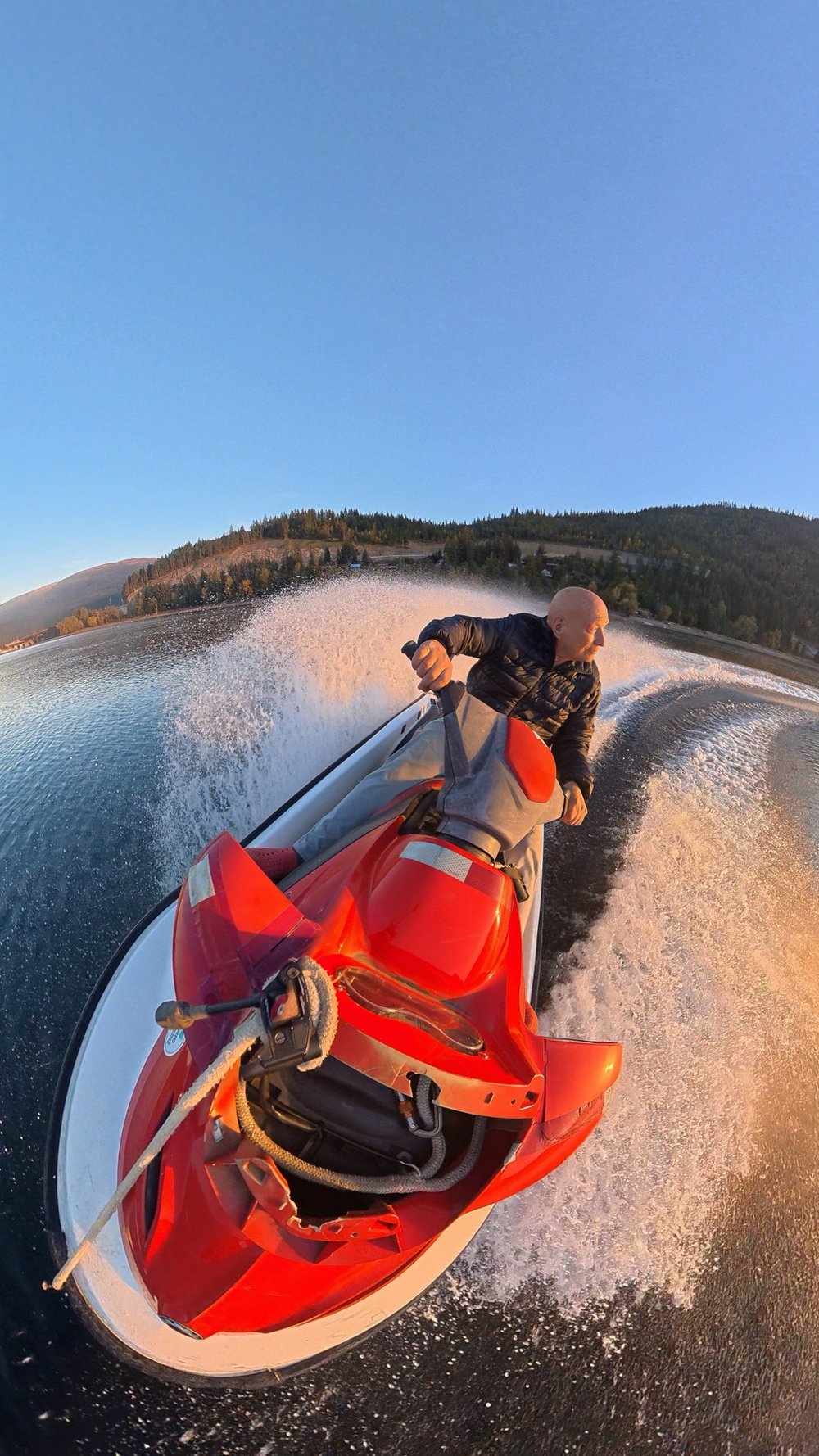 Jet ski at sunset on Shuswap Lake, spray in the air