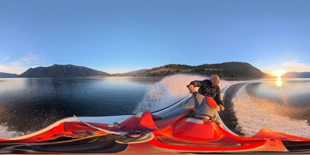 Wide panoramic shot from a jet ski crossing Shuswap Lake at sunset