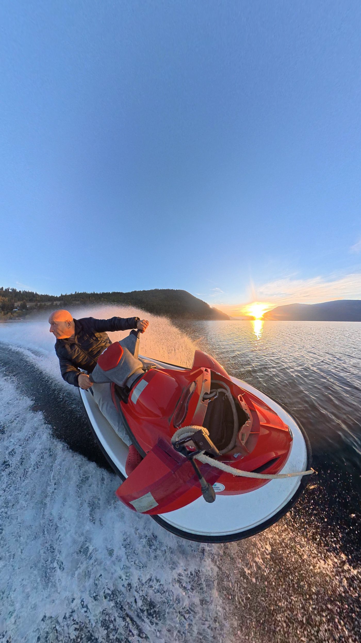Action-camera view across Shuswap Lake from a jet ski at sunset