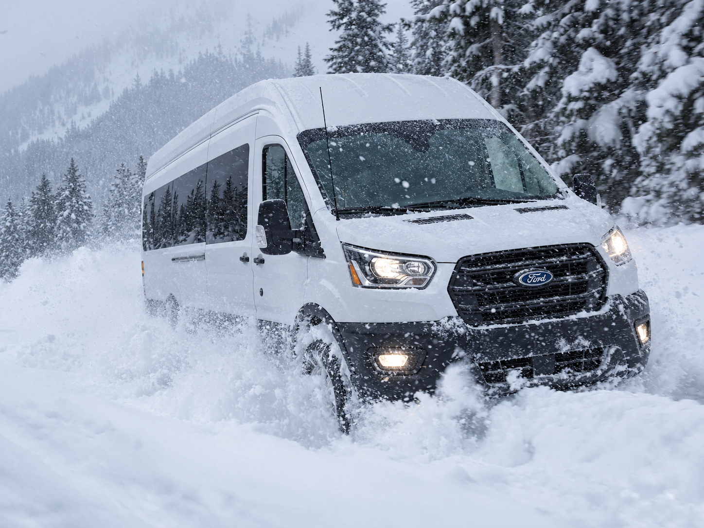 Van driving through deep fresh snow on a forested mountain road